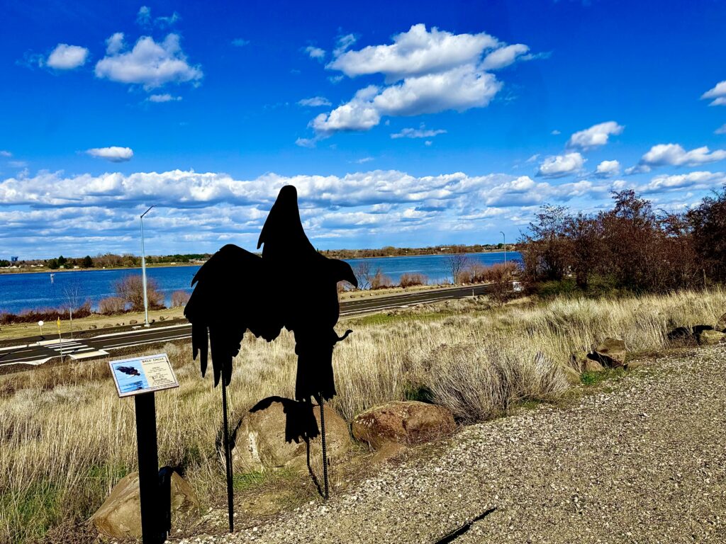 View from the Animal Trail at the REACH Museum View of the Columbia River from the REACH Museum's Animal Trail, featuring a bird silhouette interpretive display overlooking the shrub-steppe landscape and river shoreline.
